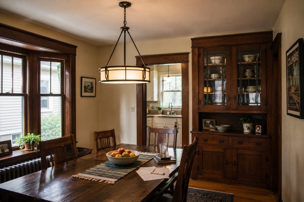 Craftsman dining room with dark wood table, built-in hutch, and drum chandelier