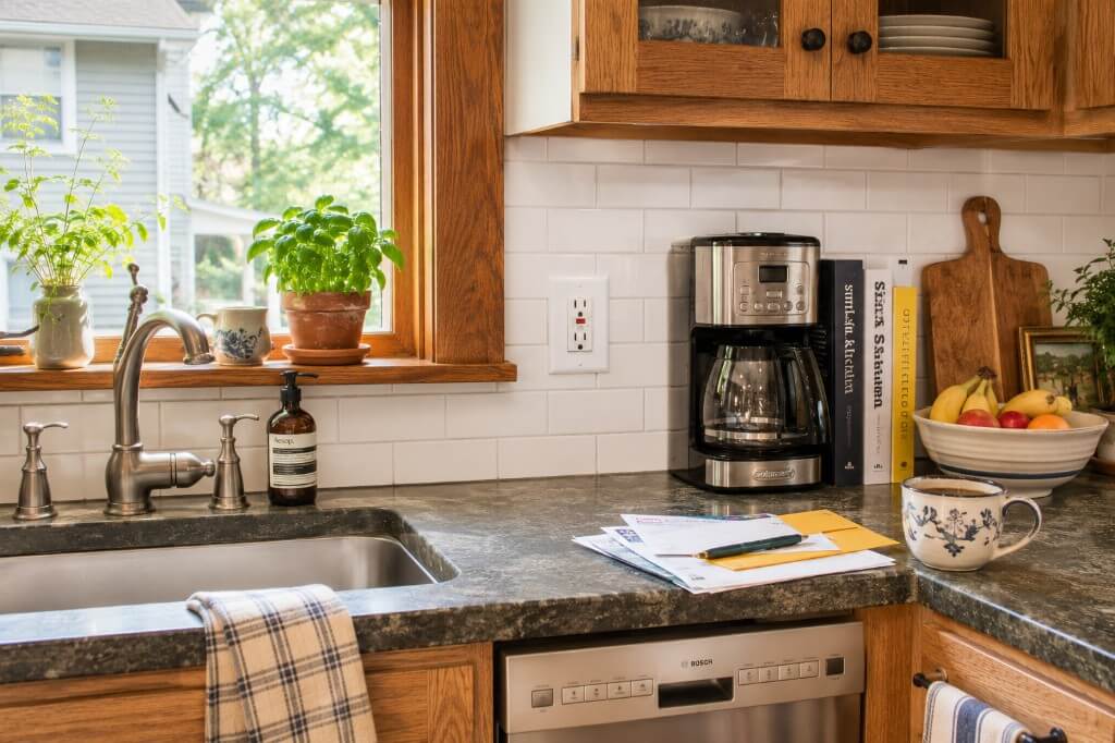 Oak kitchen cabinets with subway tile backsplash and neighborhood view