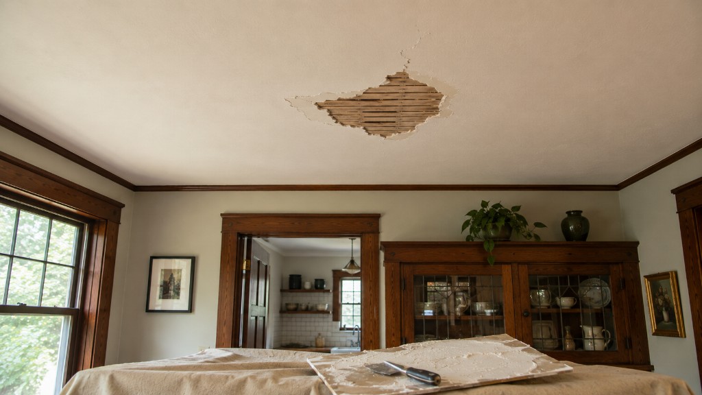 Ceiling plaster repair in progress above a craftsman dining room with wood hutch